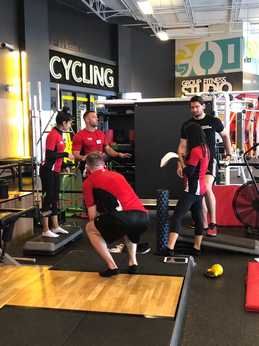 Tom Bailey coaching a client on the gym floor
